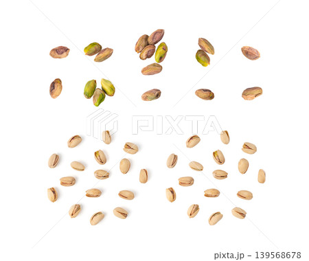 Fried salt pistachio nuts isolated. Baked pistachios pile, roasted green pistache fruit in shell on white Fried salt pistachio nuts isolated. Baked pistachios pile, roasted green pistache fruit in shell on white 139568678