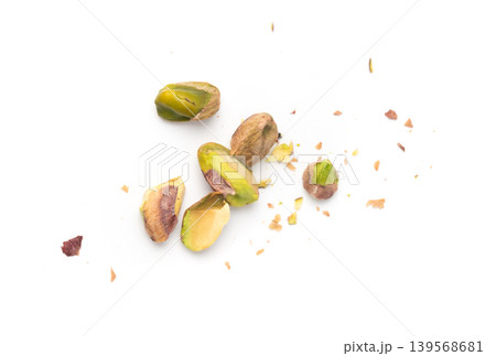 Fried salt pistachio nuts isolated. Baked pistachios pile, roasted green pistache fruits on white Fried salt pistachio nuts isolated. Baked pistachios pile, roasted green pistache fruits on white 139568681