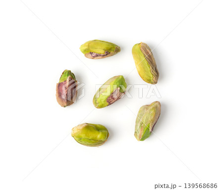 Fried salt pistachio nuts isolated. Baked pistachios pile, roasted green pistache fruits on white 139568686