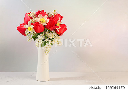 Abstract floral arrangement and banner for the screen. Still life with beautiful spring branches of blooming bird cherry, tulips, daffodils, Abstract floral arrangement and banner for the screen. Still life with beautiful spring branches of blooming bird cherry, tulips, daffodils, 139569170
