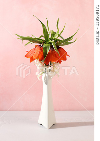 Still life with spring fritillary flowers in a vase against an elegant background. Abstract floral arrangement and banner for the screen. A floral holiday card with a summer greeting Still life with spring fritillary flowers in a vase against an elegant background. Abstract floral arrangement and banner for the screen. A floral holiday card with a summer greeting 139569171