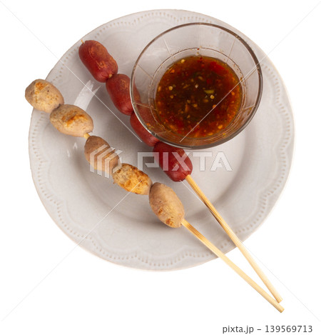 The dipping sauce for the meatballs is in a Thai style bowl isolated on white background 139569713
