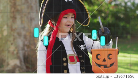 Holding pumpkin bucket and toy pirate hook, child wearing tricorn hat and vest, standing backyard Holding pumpkin bucket and toy pirate hook, child wearing tricorn hat and vest, standing backyard 139571656