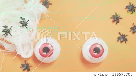 Showing white plastic eyes with pink irises veins on orange flat with spiders gauze turquoise dots Showing white plastic eyes with pink irises veins on orange flat with spiders gauze turquoise dots 139571706