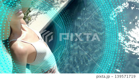 Posing woman in white one-piece swimsuit, straw hat at pool coping, turquoise overlay, copy space Posing woman in white one-piece swimsuit, straw hat at pool coping, turquoise overlay, copy space 139571719