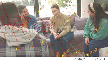 Discussing four people sitting on sofa at home, wearing beige cardigan, showing red overlays 139571761