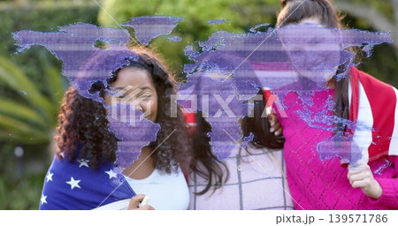 Smiling three mid-adult women posing in garden, wearing sweaters, draped flags, purple map overlay Smiling three mid-adult women posing in garden, wearing sweaters, draped flags, purple map overlay 139571786