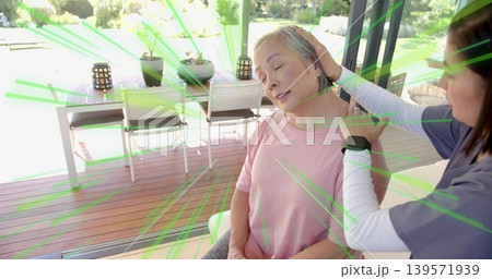 Supporting nurse in scrubs holding senior Asian woman in pink by sliding doors, deck, smartwatch 139571939