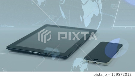 Displaying tablet showing holographic globe overlays on glossy tabletop with smartphone nearby Displaying tablet showing holographic globe overlays on glossy tabletop with smartphone nearby 139572012