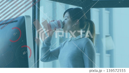 Drinking Asian woman in gray sweater near glass wall holding mug and kiosk showing red gauges Drinking Asian woman in gray sweater near glass wall holding mug and kiosk showing red gauges 139572555