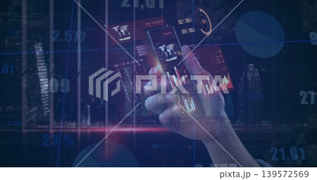 Holding right hand wearing dark cuff showing phone to camera at night skyline, with graph overlays Holding right hand wearing dark cuff showing phone to camera at night skyline, with graph overlays 139572569