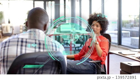 Leaning woman in red blouse and jeans pondering at glass desk with holographic HUD, copy space Leaning woman in red blouse and jeans pondering at glass desk with holographic HUD, copy space 139572891