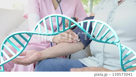 Measuring nurse in pink scrubs taking patient blood pressure at clinic, with cuff, stethoscope, DNA 139573041