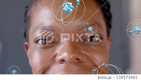 Showing African American woman with braids revealing skin texture in studio, with molecular orbits 139573401