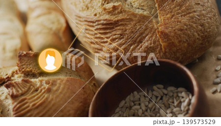 Showing crusty artisan loaf on counter, with sliced baguette, bowl of sunflower seeds, UI overlay Showing crusty artisan loaf on counter, with sliced baguette, bowl of sunflower seeds, UI overlay 139573529