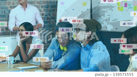 Discussing team of five in casual wear planning in office, with smartphone, whiteboard social icons 139573555