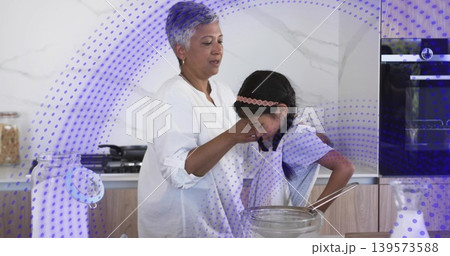 Wiping mature man white-shirt guiding child in apron at kitchen, mixing bowl, whisk, purple overlay Wiping mature man white-shirt guiding child in apron at kitchen, mixing bowl, whisk, purple overlay 139573588