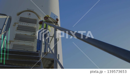 Standing turbine tech in hard hat and hi-vis vest leaning on railing with laptop, copy space Standing turbine tech in hard hat and hi-vis vest leaning on railing with laptop, copy space 139573653