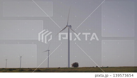 Featuring large central wind turbine rotating three-blade rotor on grassy plain, showing grid Featuring large central wind turbine rotating three-blade rotor on grassy plain, showing grid 139573654