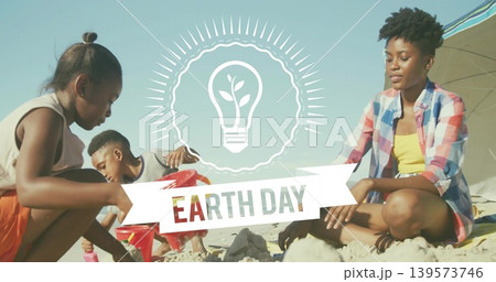 Building family sculpting sandcastles at beach shoreline, Earth Day banner, adult wearing plaid top Building family sculpting sandcastles at beach shoreline, Earth Day banner, adult wearing plaid top 139573746
