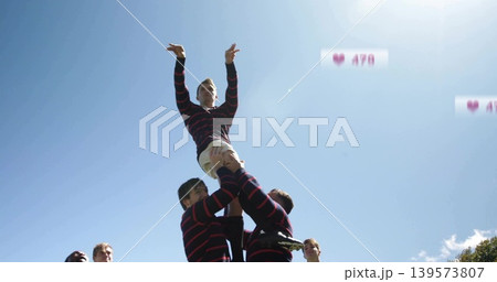 Lifting athlete reaching on grass, in striped jersey and white shorts, cleats, tape, heart icons Lifting athlete reaching on grass, in striped jersey and white shorts, cleats, tape, heart icons 139573807