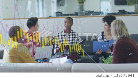 Leading central woman wearing checkered shirt holding tablet in office lounge with laptop charts 139573941