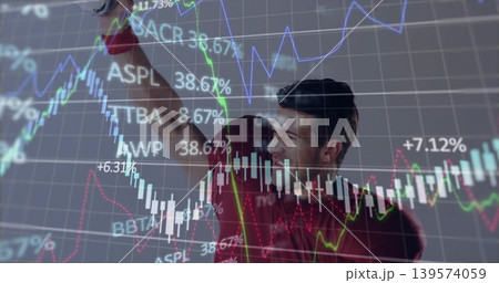 Pointing man in red shirt gesturing to market screen in office showing candlesticks, percent labels Pointing man in red shirt gesturing to market screen in office showing candlesticks, percent labels 139574059