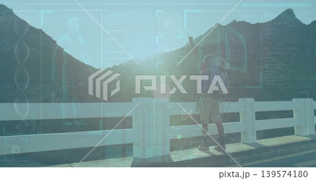 Crossing hiker wearing hiking gear, carrying pack along white bridge railing with HUD, copy space Crossing hiker wearing hiking gear, carrying pack along white bridge railing with HUD, copy space 139574180