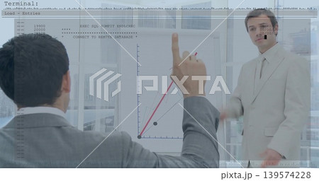 Pointing man wearing suit and tie raising red marker at flip chart near windows, terminal overlay Pointing man wearing suit and tie raising red marker at flip chart near windows, terminal overlay 139574228