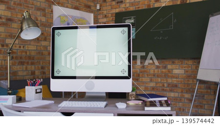 Displaying white all-in-one monitor with stand on desk in study, with keyboard, lamp, chalkboard Displaying white all-in-one monitor with stand on desk in study, with keyboard, lamp, chalkboard 139574442