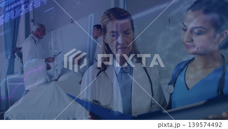 Reviewing doctor in white coat and nurse in blue scrubs checking chart at ward, stethoscopes Reviewing doctor in white coat and nurse in blue scrubs checking chart at ward, stethoscopes 139574492