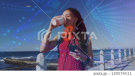 Sipping woman red-polka-top denim-vest holding paper and travel cups on promenade, digital overlays Sipping woman red-polka-top denim-vest holding paper and travel cups on promenade, digital overlays 139574511