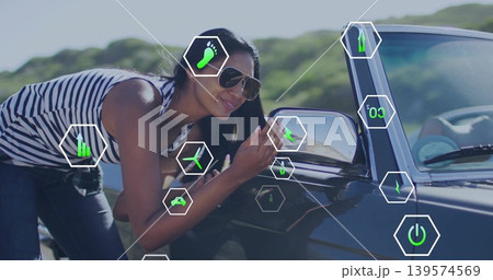 Leaning Indian woman adjusting mirror on dark car on road wearing striped top shades, AR overlays Leaning Indian woman adjusting mirror on dark car on road wearing striped top shades, AR overlays 139574569