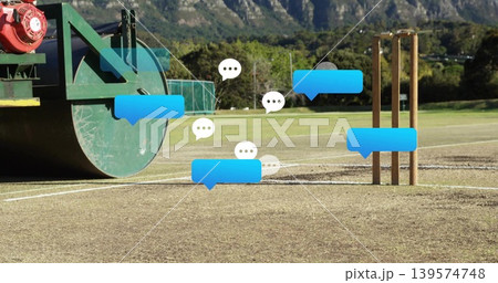 Sitting green field roller on left of cricket pitch, showing stumps and chat bubbles, copy space 139574748