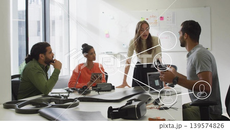 Leading standing woman leaning on table guiding design meeting in office, with drone, VR headset Leading standing woman leaning on table guiding design meeting in office, with drone, VR headset 139574826