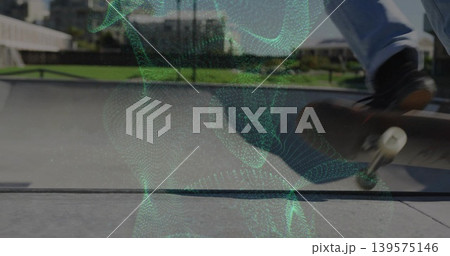 Skateboarding skater tricking board in jeans and dark skate shoes in bowl with green mesh overlay Skateboarding skater tricking board in jeans and dark skate shoes in bowl with green mesh overlay 139575146