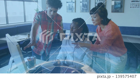 Working team around seated man wearing white shirt operating computer in office, holographic UI Working team around seated man wearing white shirt operating computer in office, holographic UI 139575407