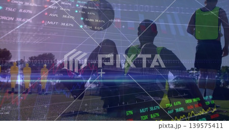 Squatting player wearing neon training vest on grassy field, with yellow dummies and market overlay 139575411