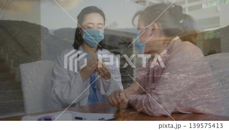 Preparing clinician handling vial with patient at clinic, with white coat, masks, seascape overlay Preparing clinician handling vial with patient at clinic, with white coat, masks, seascape overlay 139575413