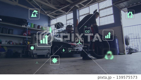 Bending mechanic in coveralls lifting tire near sports car in garage with AR overlays, copy space Bending mechanic in coveralls lifting tire near sports car in garage with AR overlays, copy space 139575573