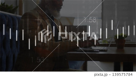 Working mature man in patterned blazer typing on laptop at cafe, with potted plant, data overlay 139575784