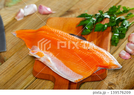 Raw trout fillet on wooden table 139576209
