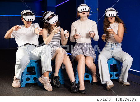 Young women playing virtual reality games in gaming center Young women playing virtual reality games in gaming center 139576338