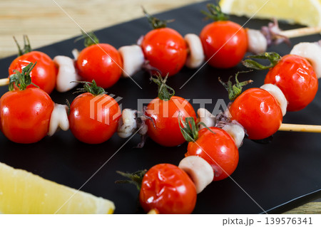 Grilled mini calamari with cherry tomatoes Grilled mini calamari with cherry tomatoes 139576341