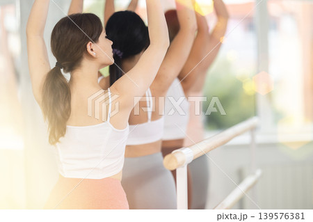 Group of girls ballerinas will learn to stand in third position during ballet rehearsal Group of girls ballerinas will learn to stand in third position during ballet rehearsal 139576381