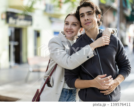 Young couple hugging each other on city street 139576411