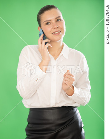 woman office employee standing with mobile phone on chroma key background woman office employee standing with mobile phone on chroma key background 139576416