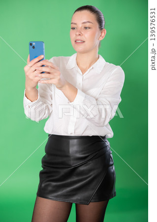 woman uses qr code for online payment on a green background woman uses qr code for online payment on a green background 139576531
