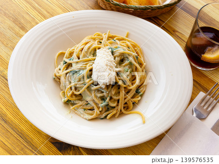 Tasty spinach pasta with ricotta cheese at plate Tasty spinach pasta with ricotta cheese at plate 139576535