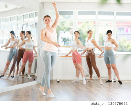 Young female dancer performing solo dance at ballet class Young female dancer performing solo dance at ballet class 139576631